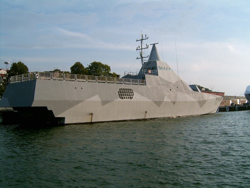 modern stealth warship in harbor