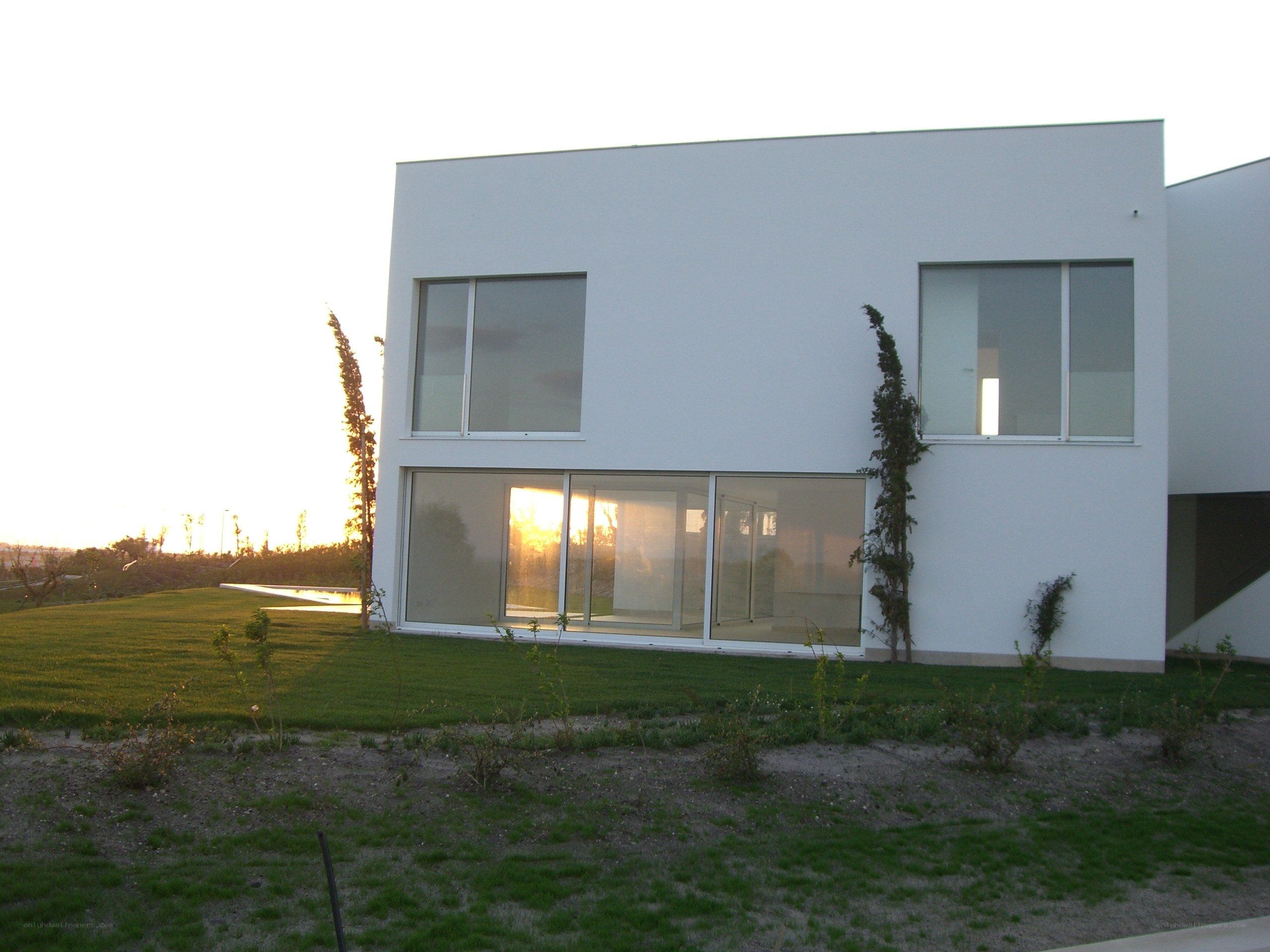 Modern white house at sunset
