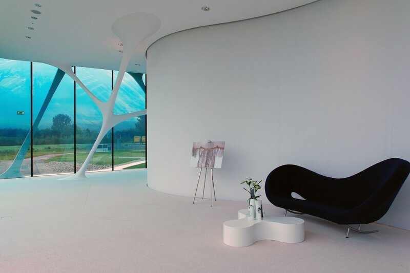 Modern white interior with black chair