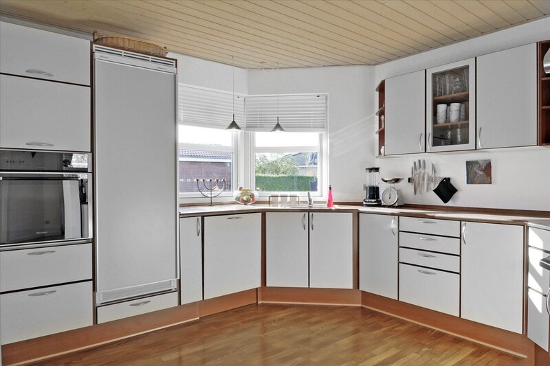 Modern white kitchen with wood accents