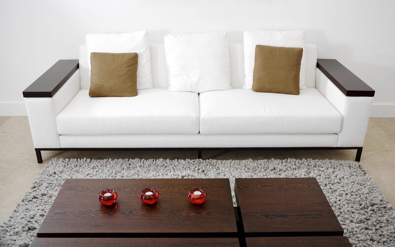 Modern white sofa with wooden coffee table