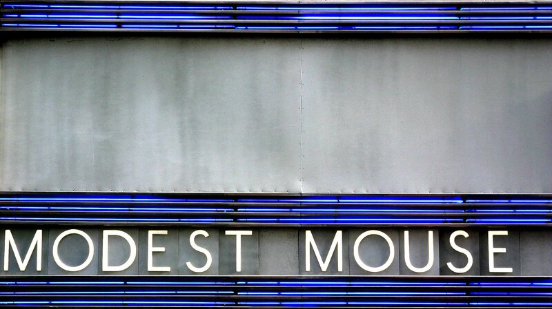 Modest Mouse sign with blue neon
