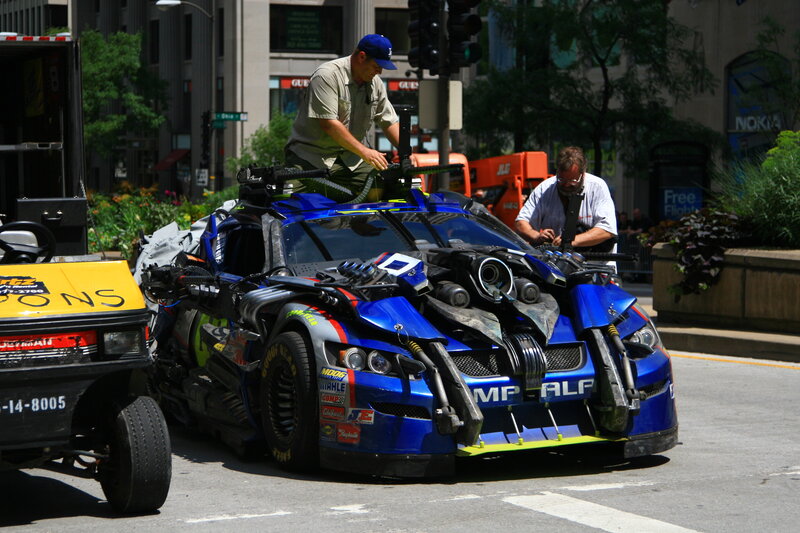 modified blue car on city street