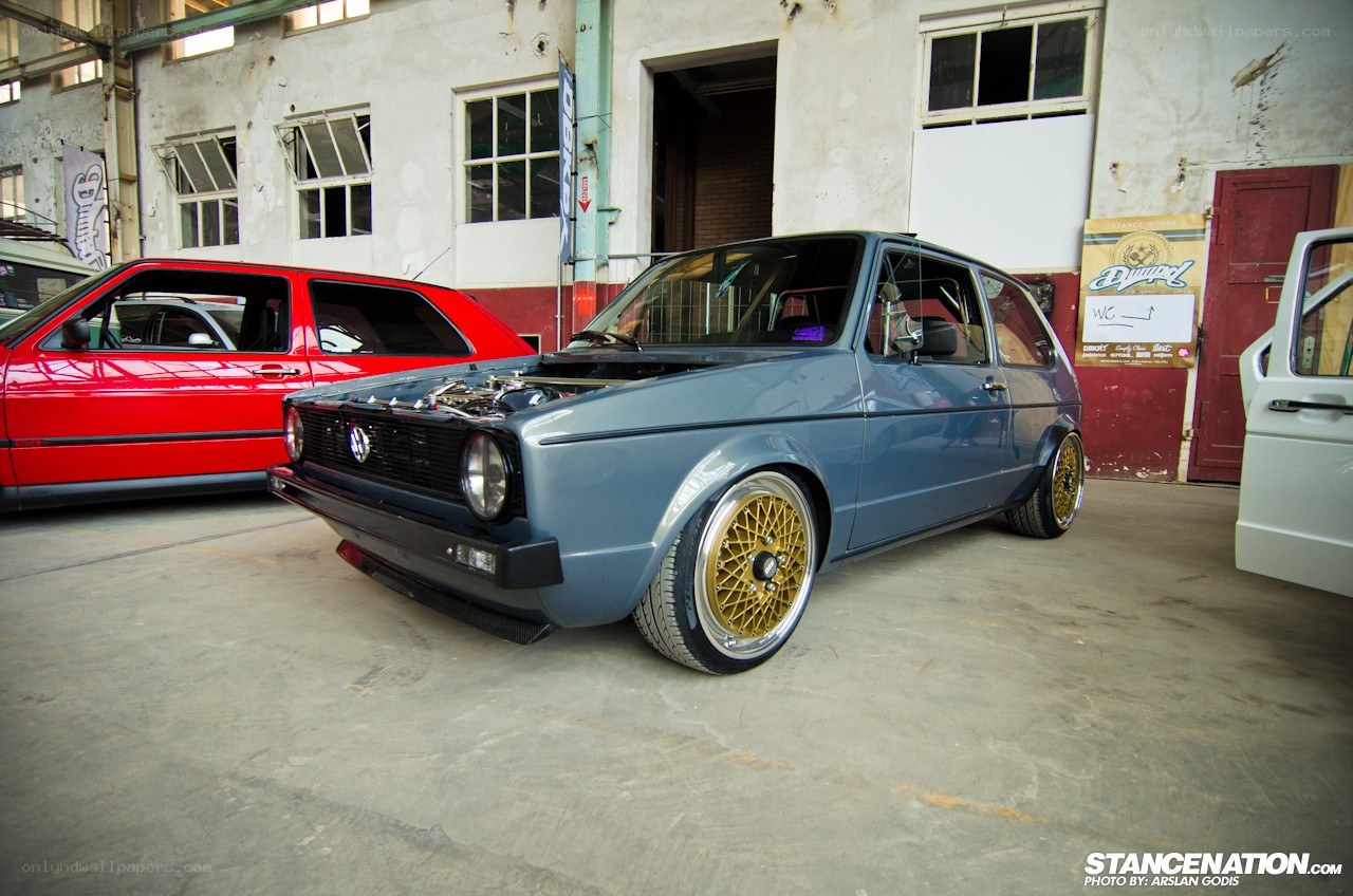 Modified blue VW Golf in garage