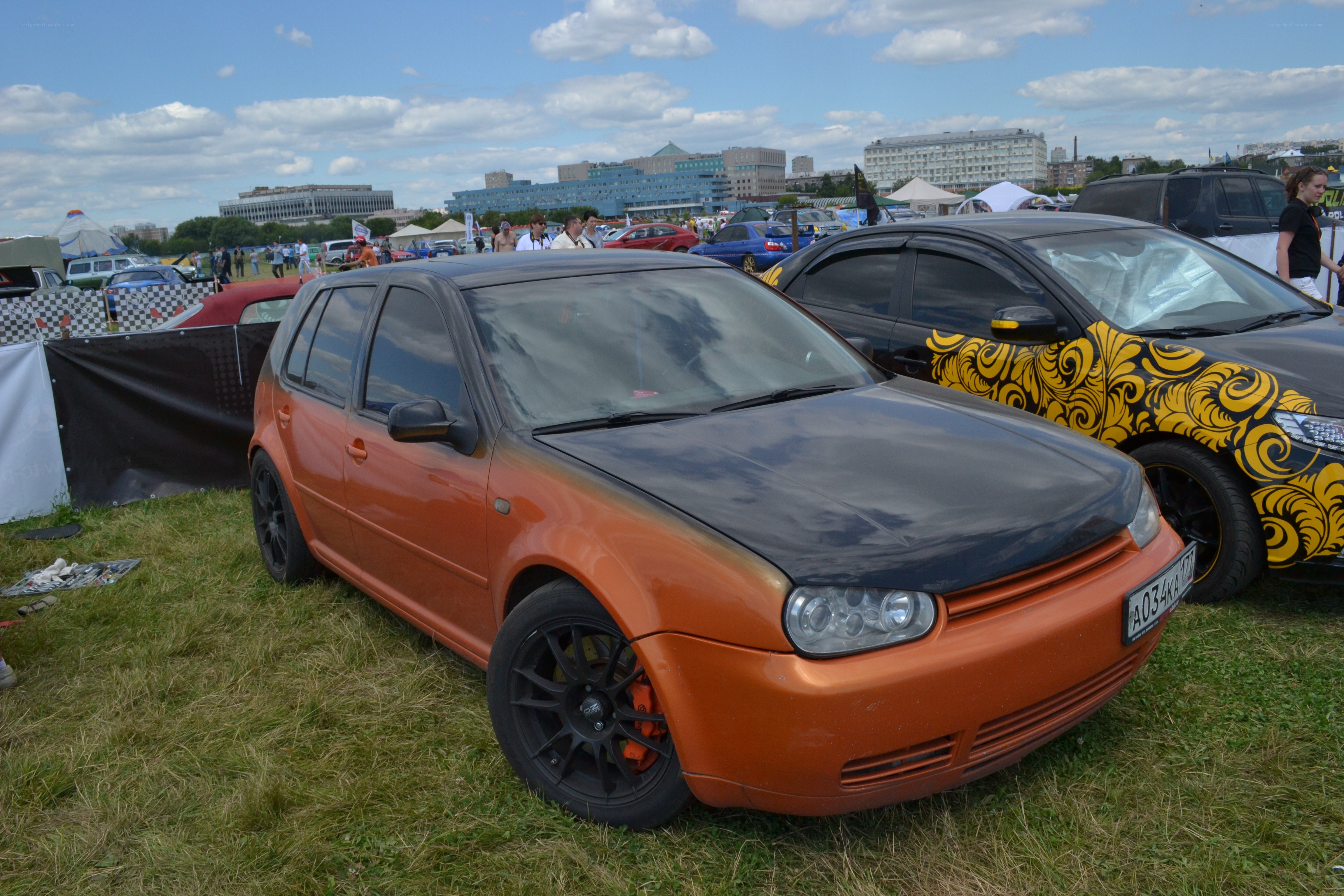 Modified orange car at outdoor show