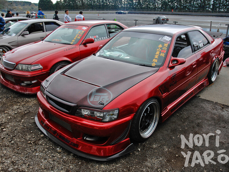 Modified red cars at a race track