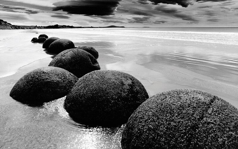 Moeraki Boulders on Beach — Black, Dramatic, Photograph, Ocean, Sky
