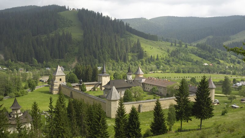 Monastery in Mountain Valley — Green, Serene, Afternoon, Photograph, Mountains