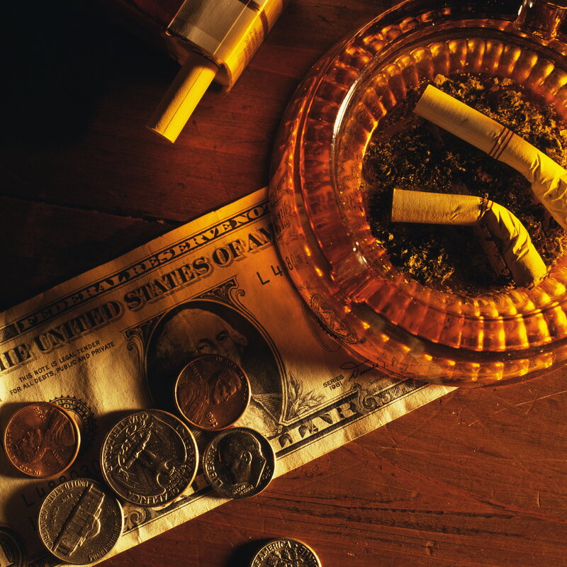 money and cigarettes on table