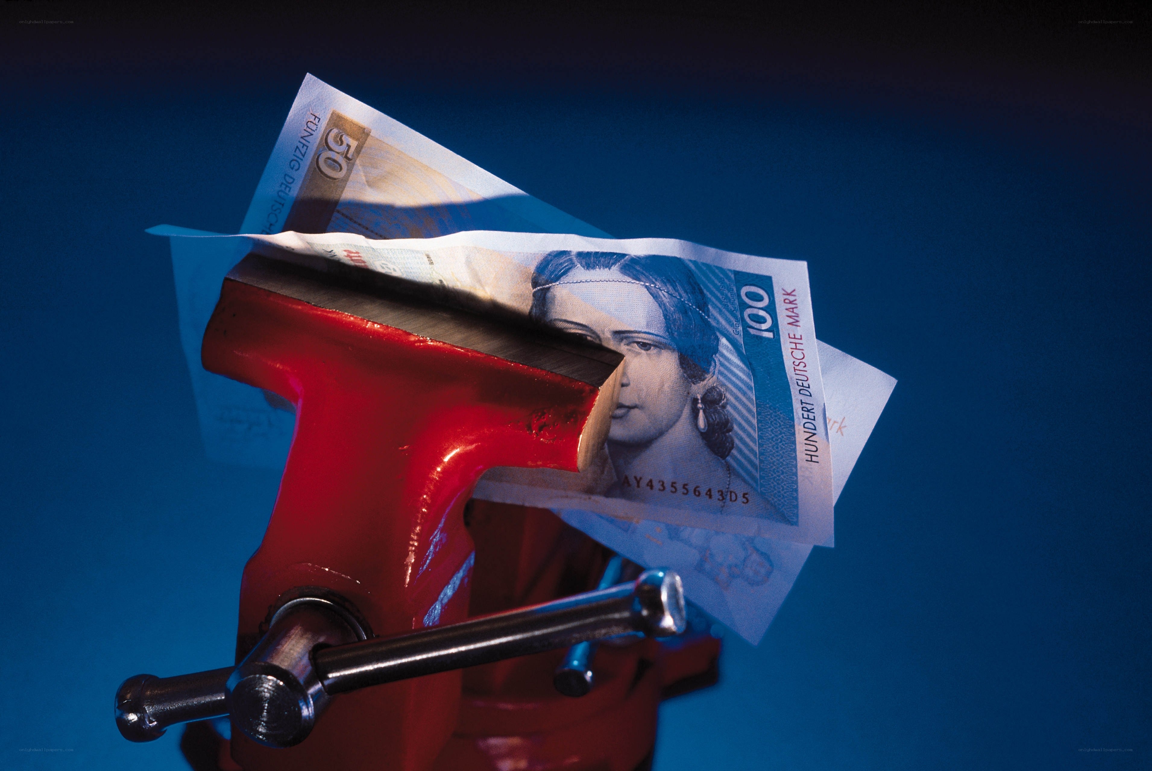 Money being squeezed in a vise