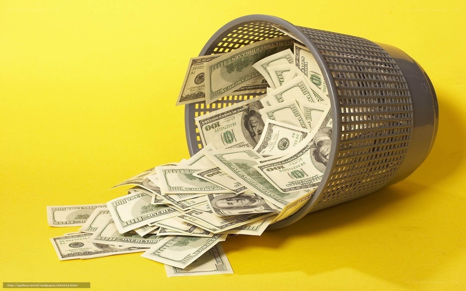 Money falling from a trash can