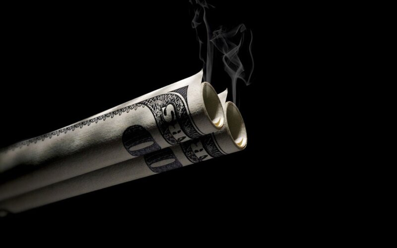 money rolled into guns