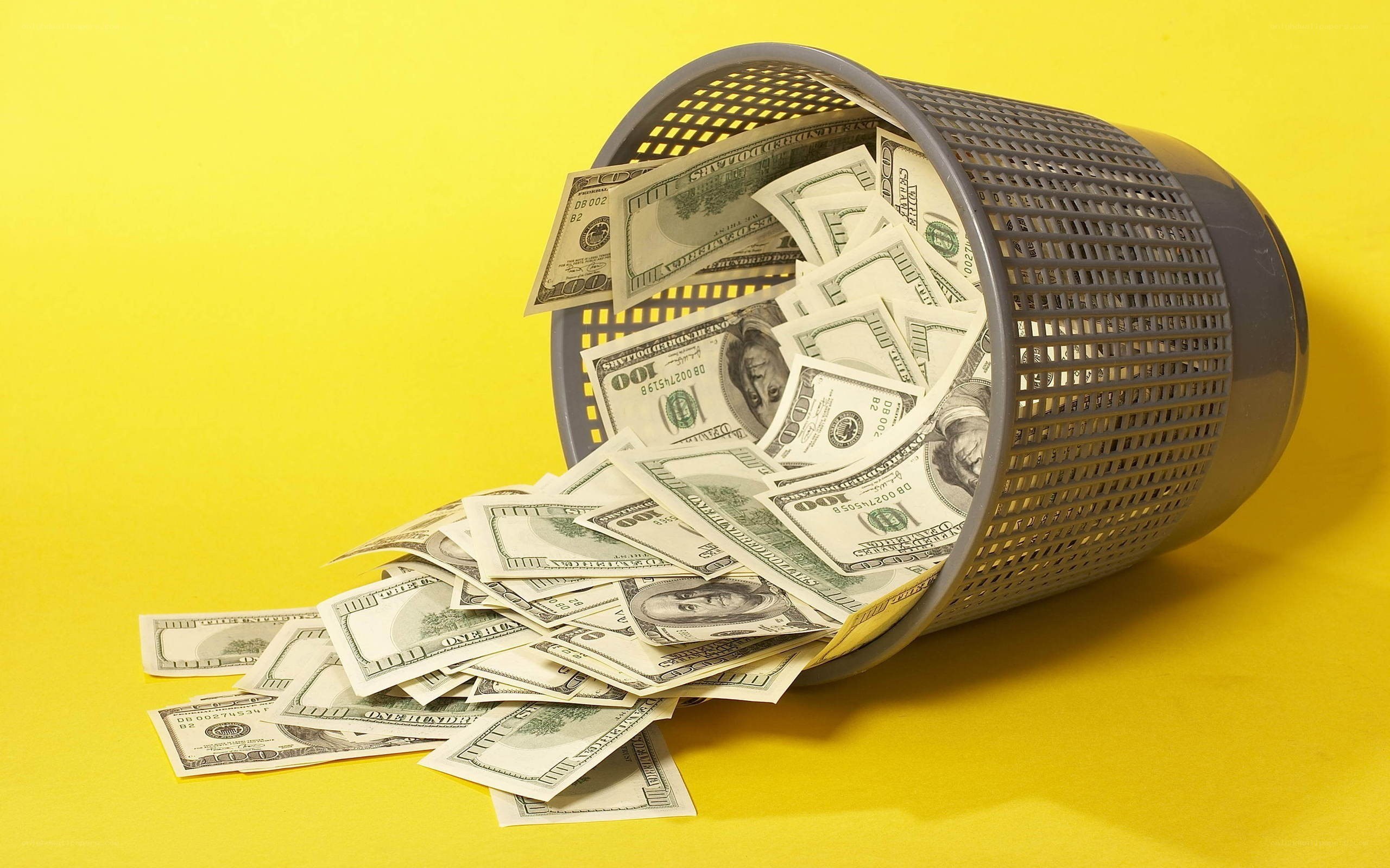 Money spilled from a trash can
