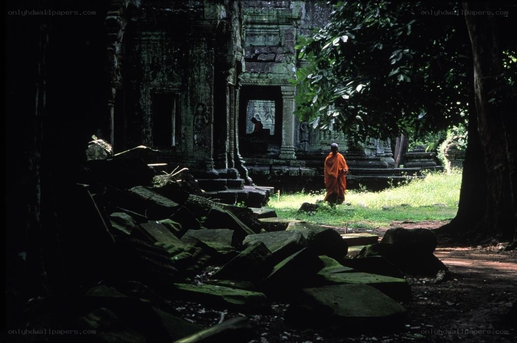 Monk at ancient temple ruins