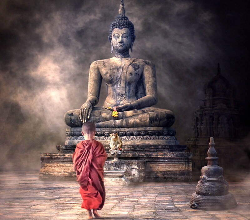 Monk Before Buddha Statue