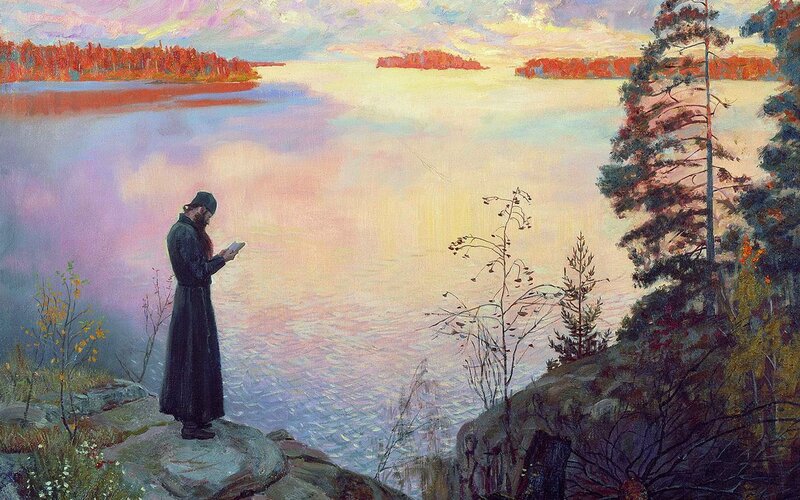 Monk by the lake at sunset