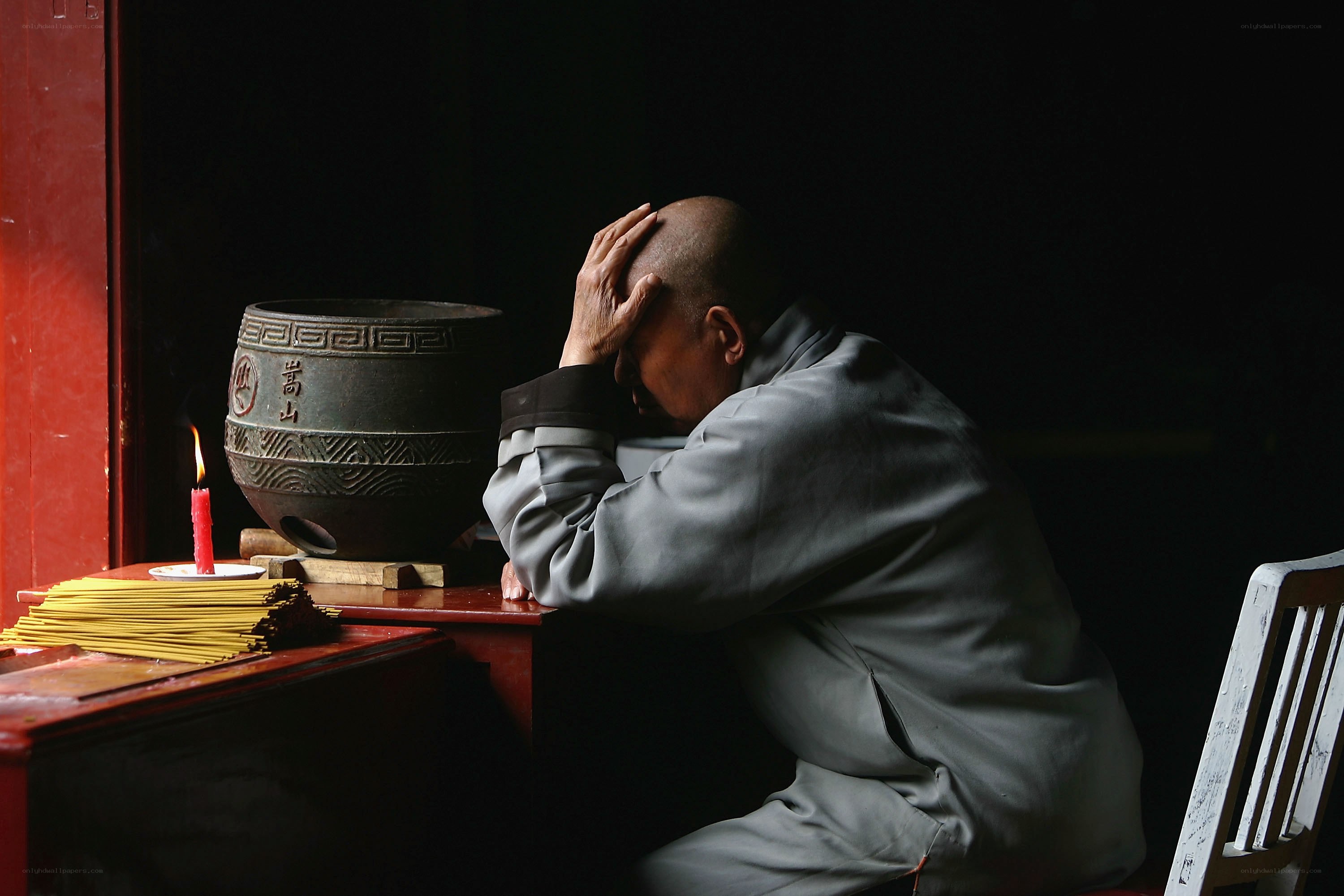 Monk in prayer at temple
