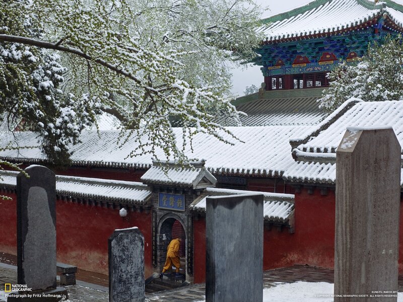 Monk in Snowy Temple Courtyard