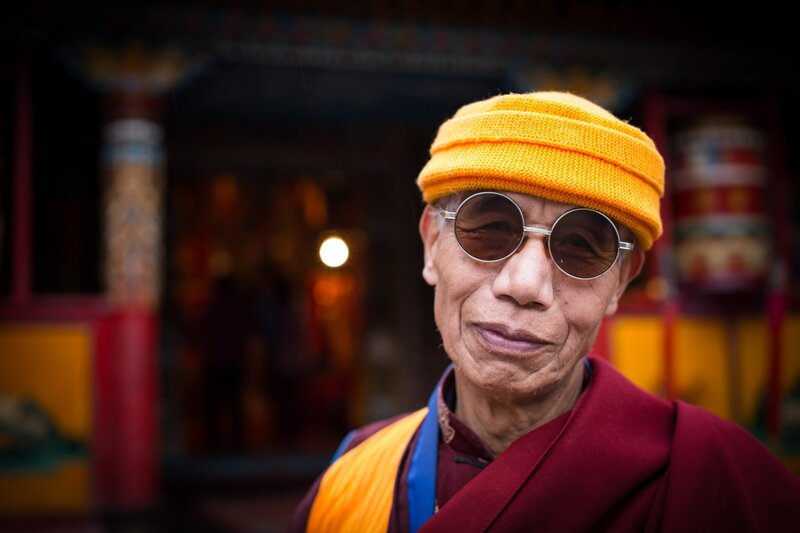 Monk in sunglasses and hat