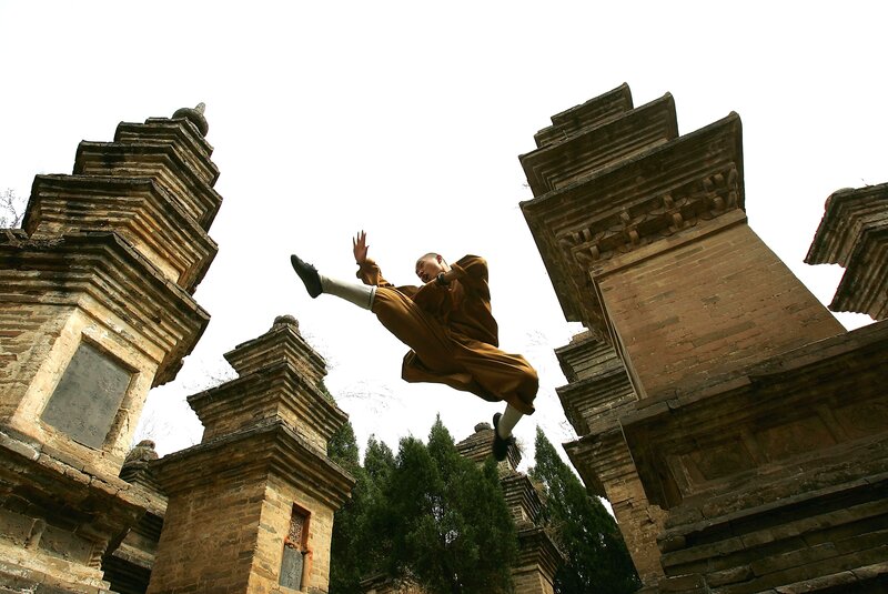 Monk performing martial arts jump