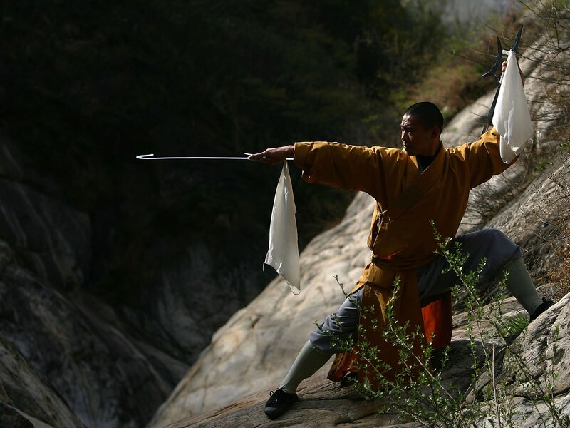 Monk practicing with staff
