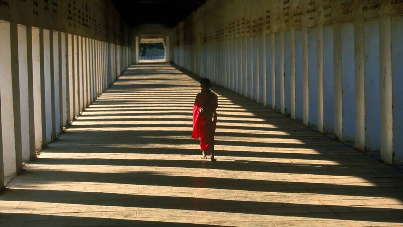Monk walking in a corridor