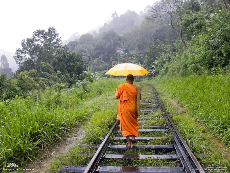 Monk walking on train tracks