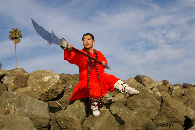 Monk with a weapon on rocks