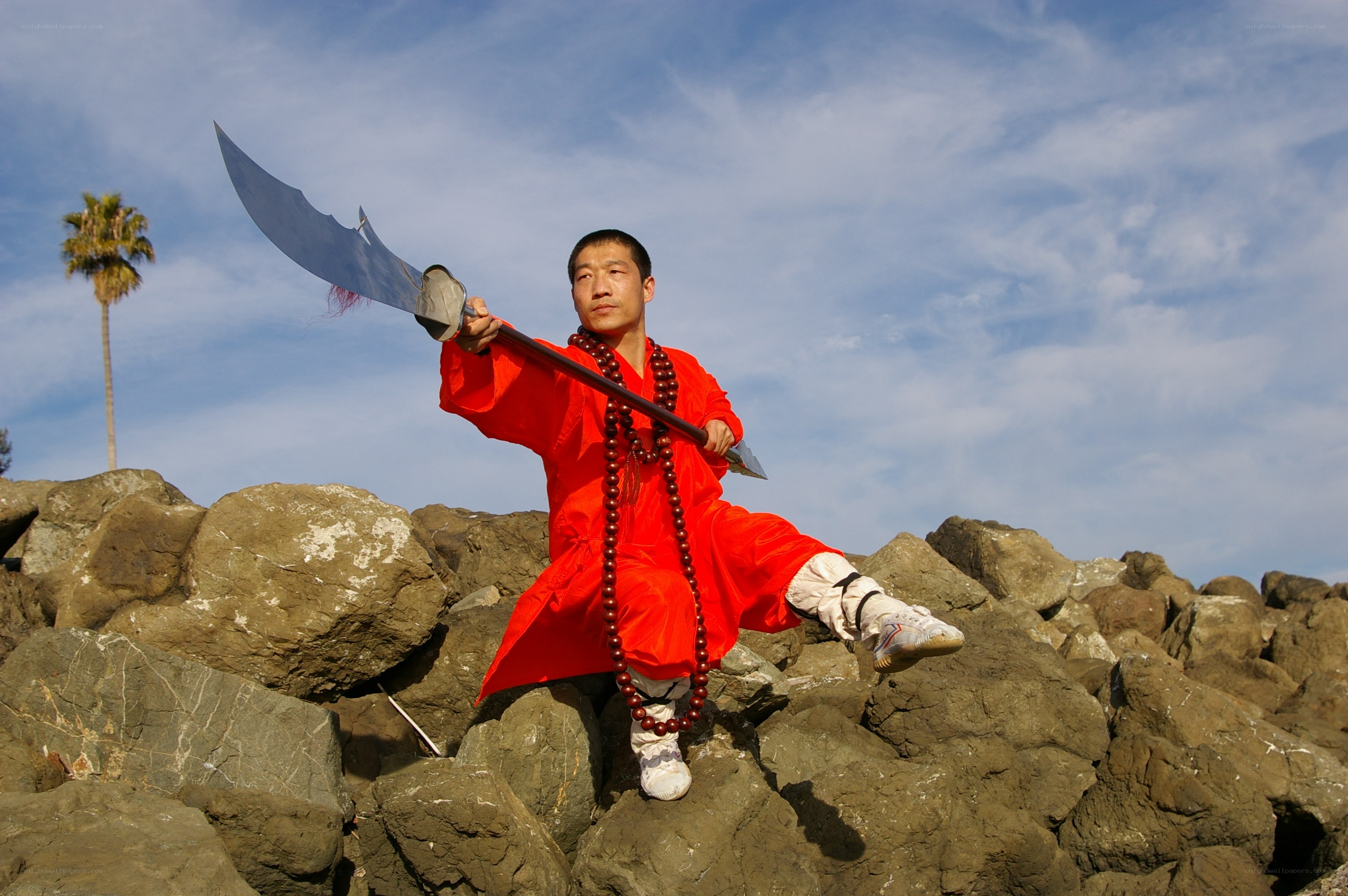 Monk with a weapon on rocks