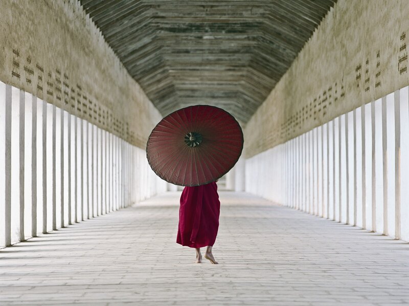 Monk with red umbrella