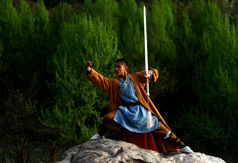 Monk with sword on rock