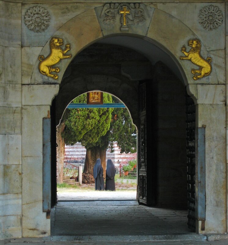 Monks at a stone archway