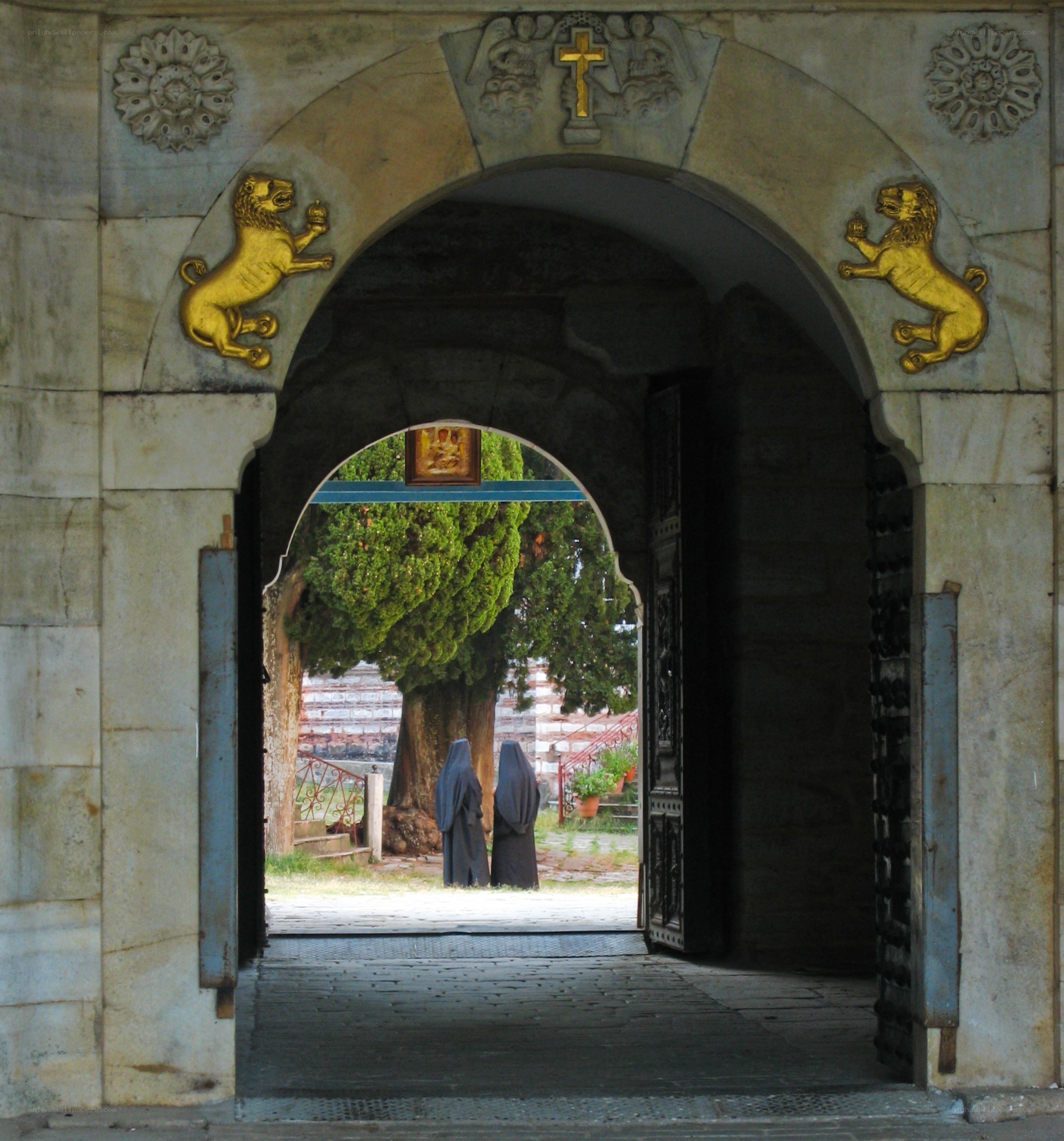 Monks at a stone archway
