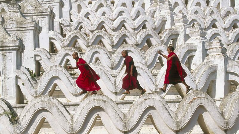 Monks climbing temple stairs