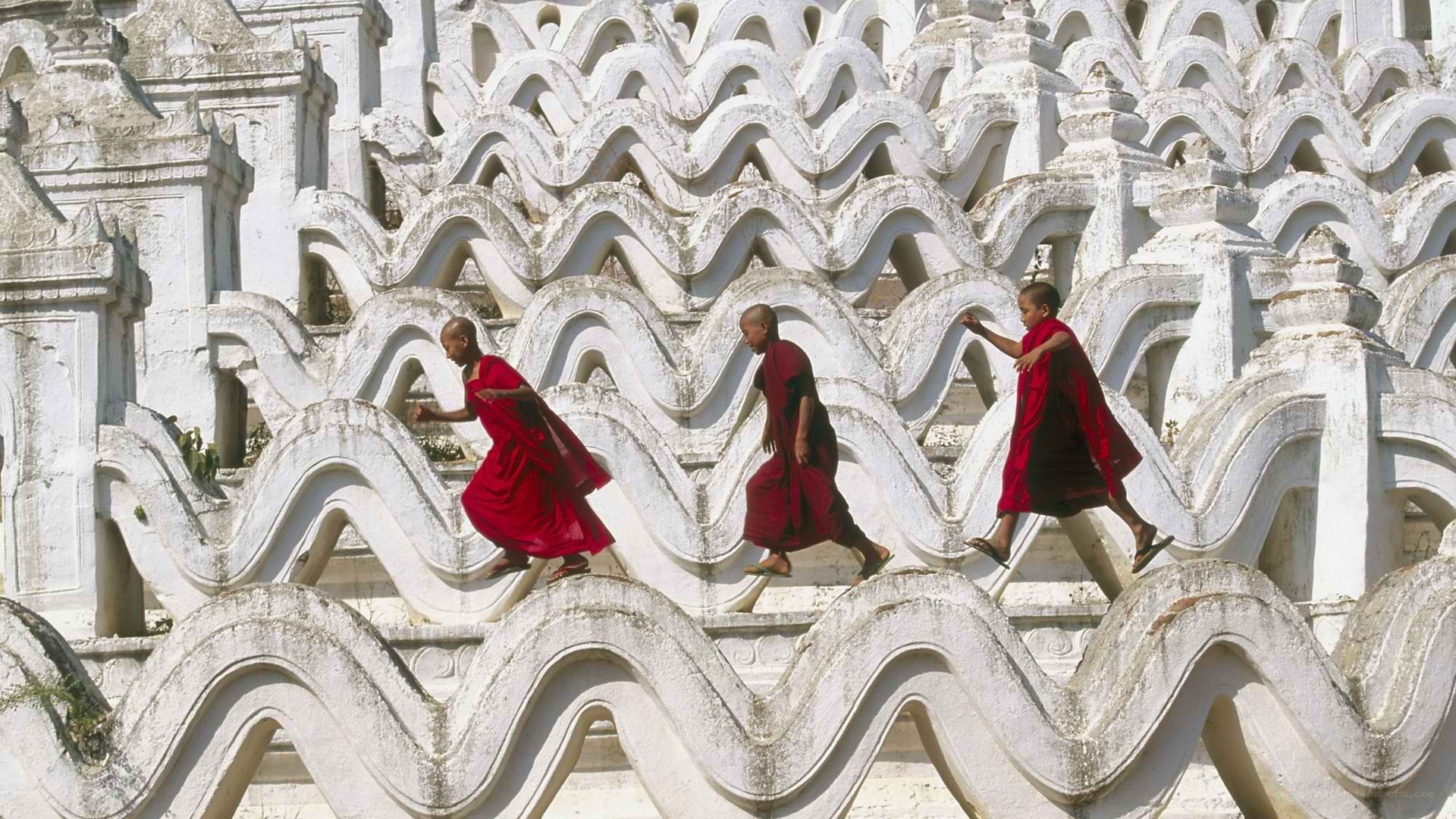 Monks climbing temple stairs