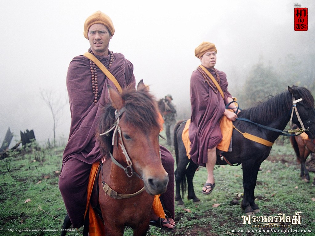 Monks on horseback in fog