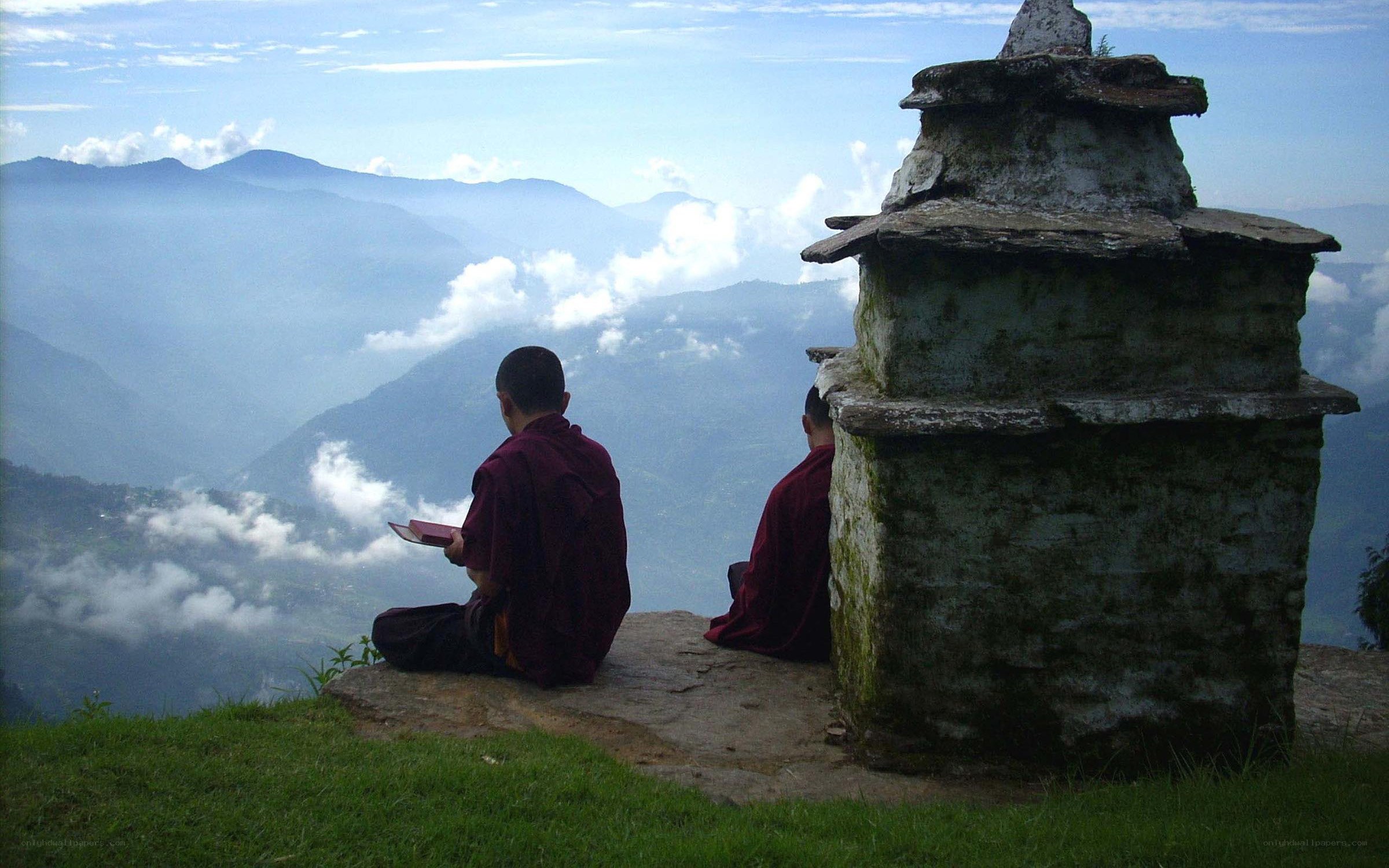 Monks overlooking mountain valley