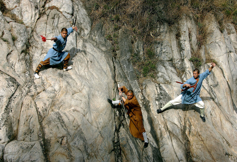 Monks practicing martial arts on a cliff