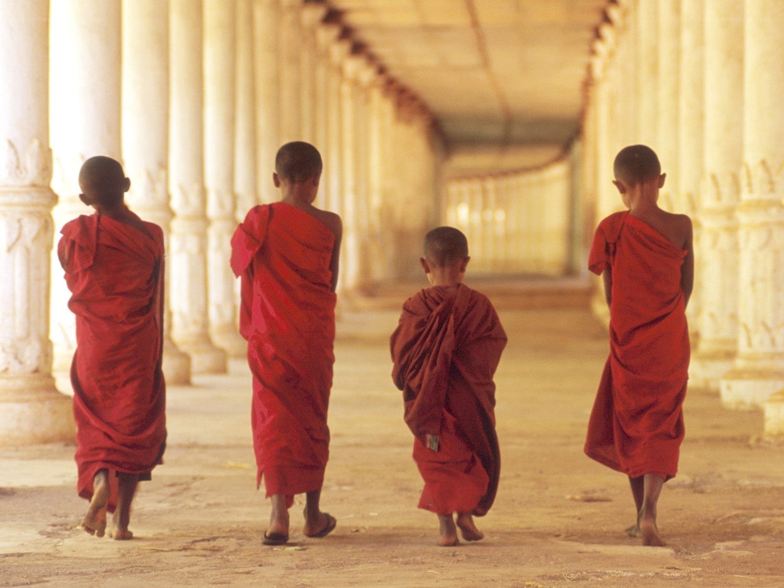 Monks walking in a temple corridor
