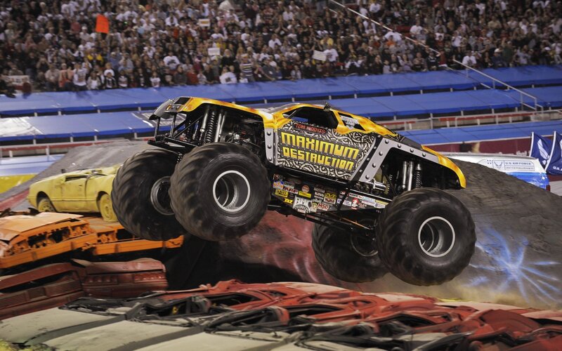 Monster truck jumping over cars