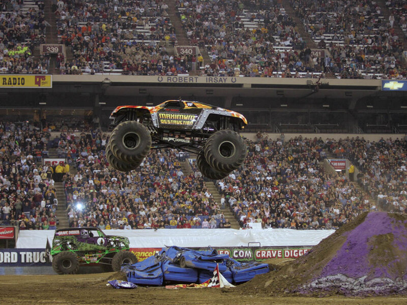 Monster truck jumping over cars