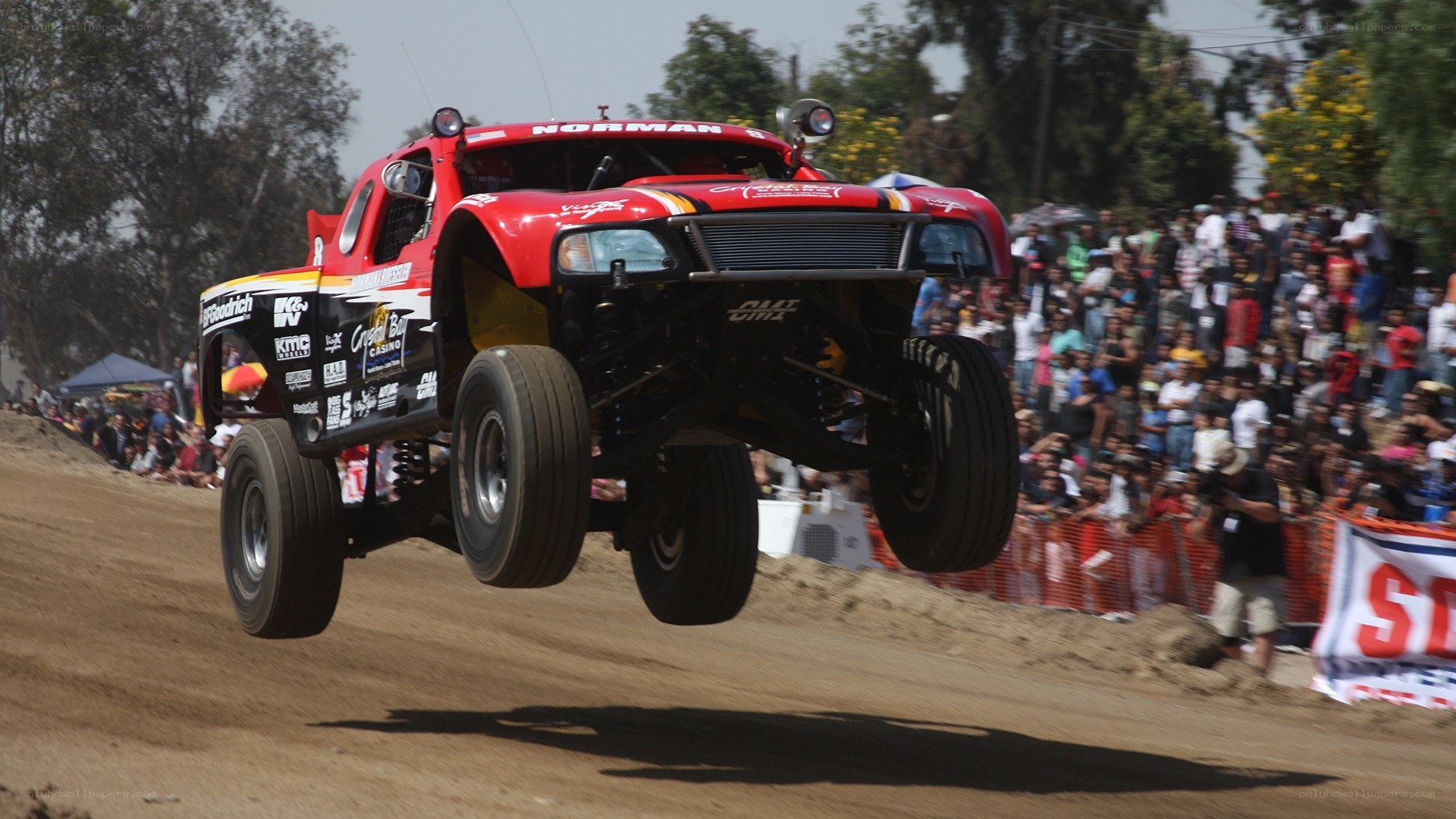 Monster truck jumping over dirt