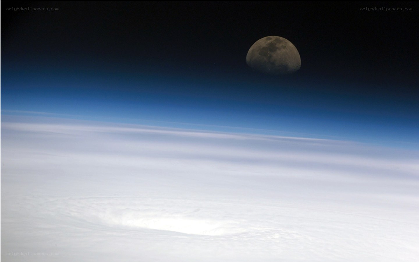 Moon above Earth's clouds