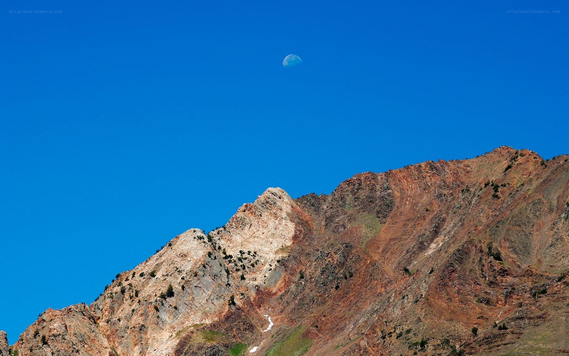 Moon above mountain peak