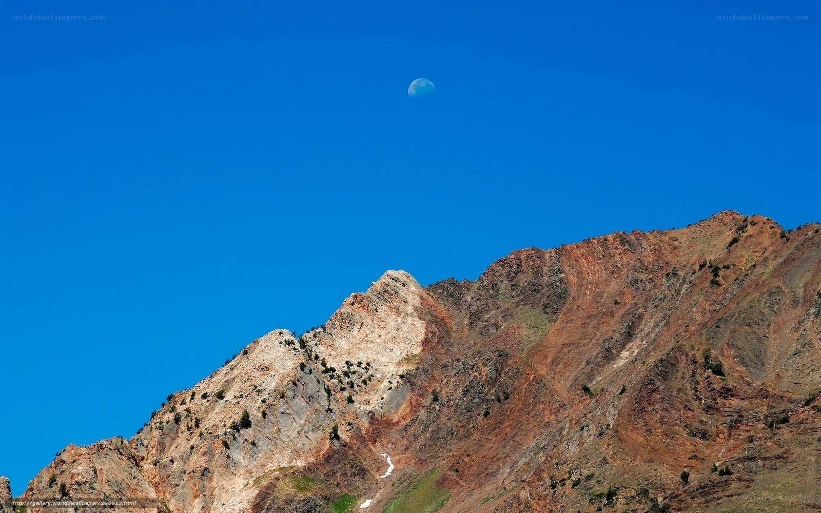 Moon above mountain peak