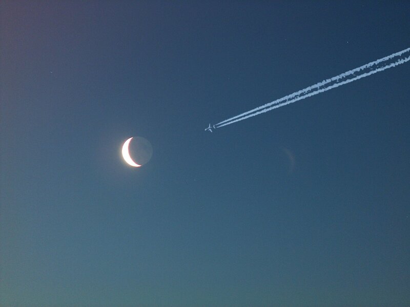 Moon and airplane contrail