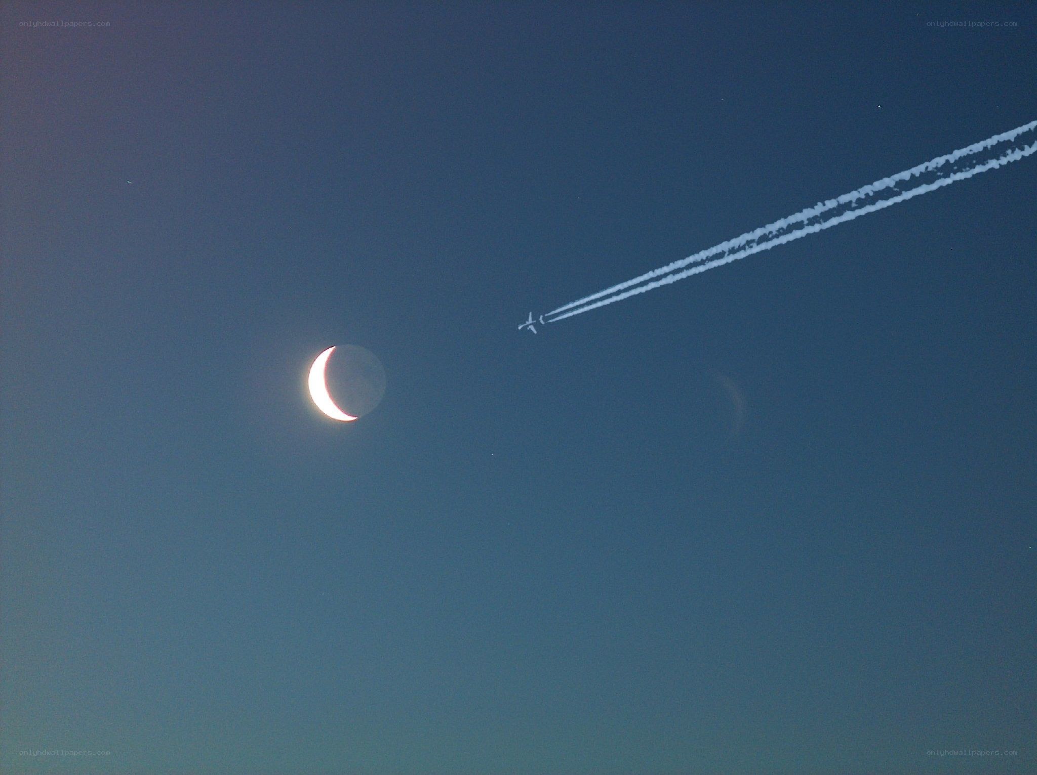 Moon and airplane contrail