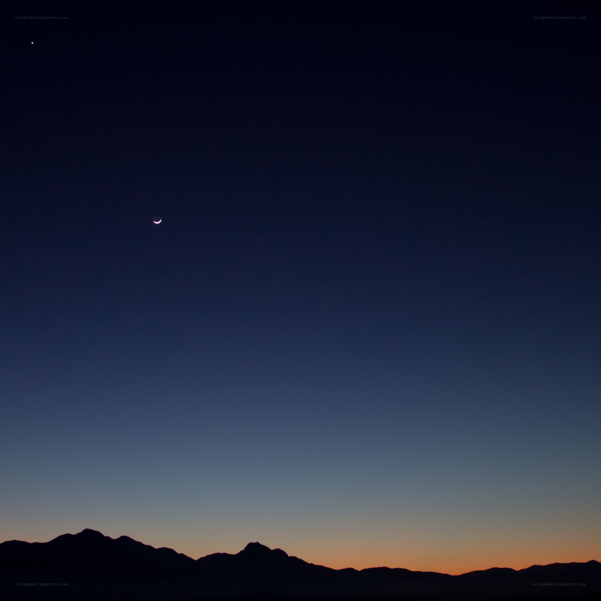 Moon and stars over mountains