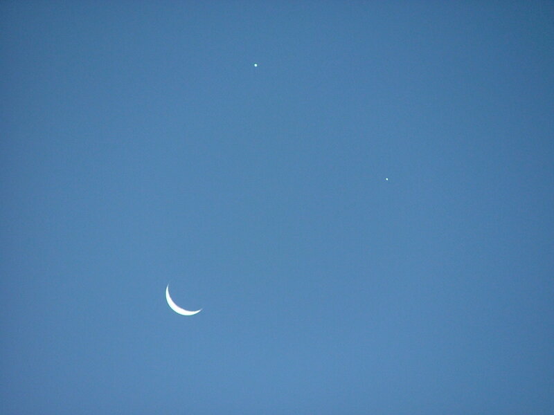 Moon and two planets in blue sky