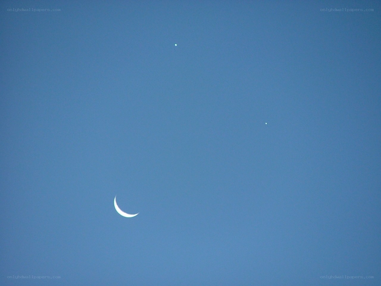 Moon and two planets in blue sky